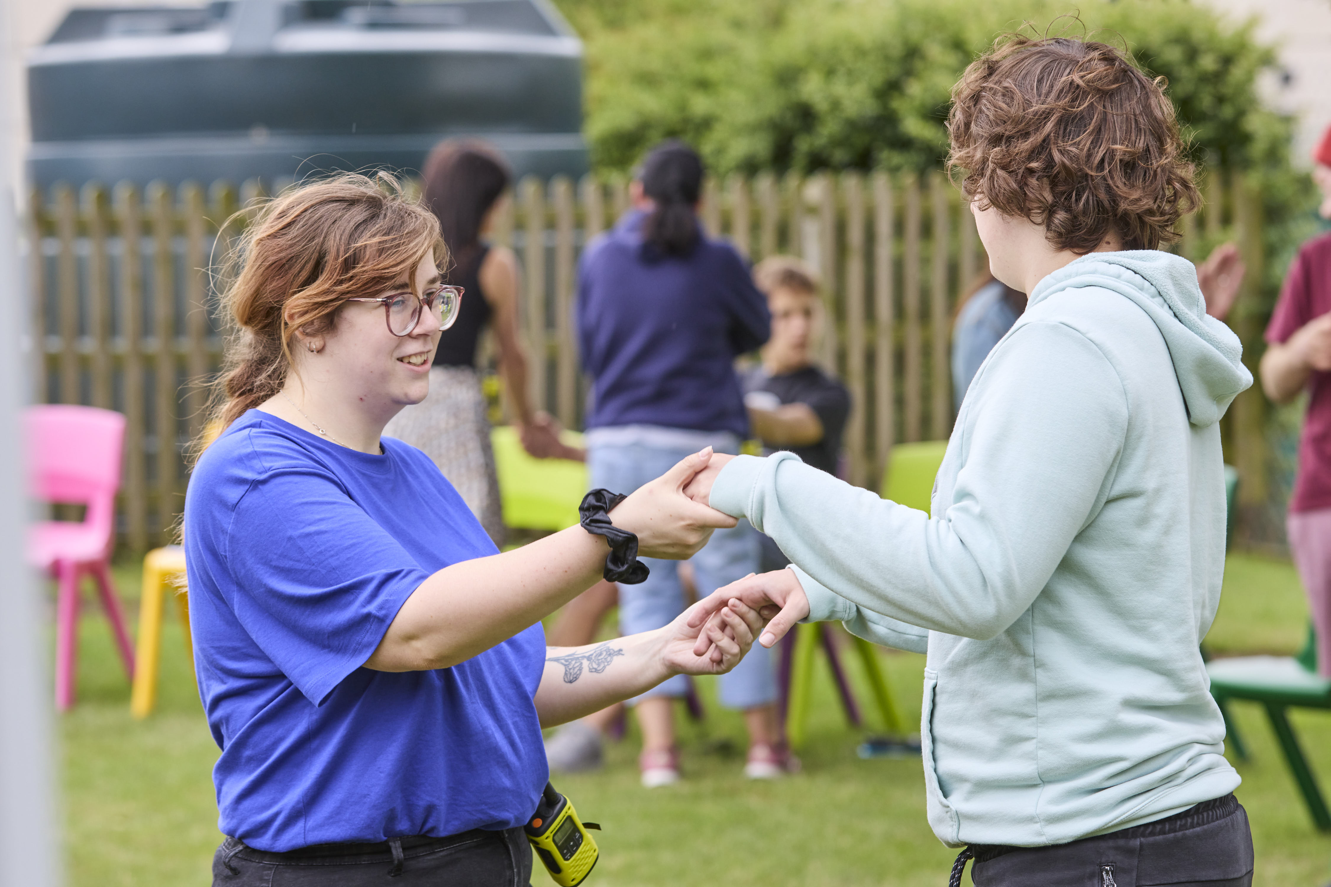 Children playing outside holding hands