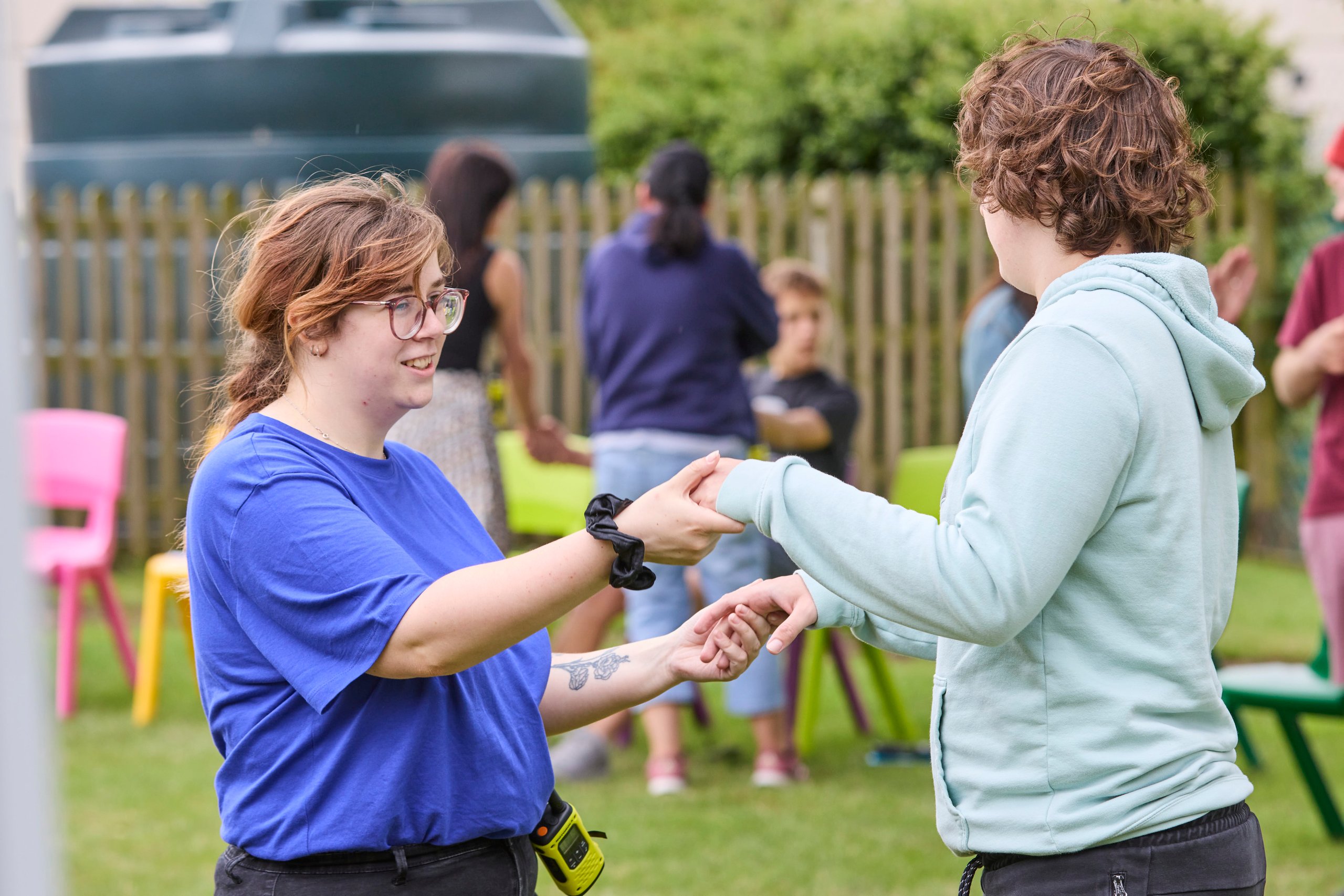 Children playing outside holding hands